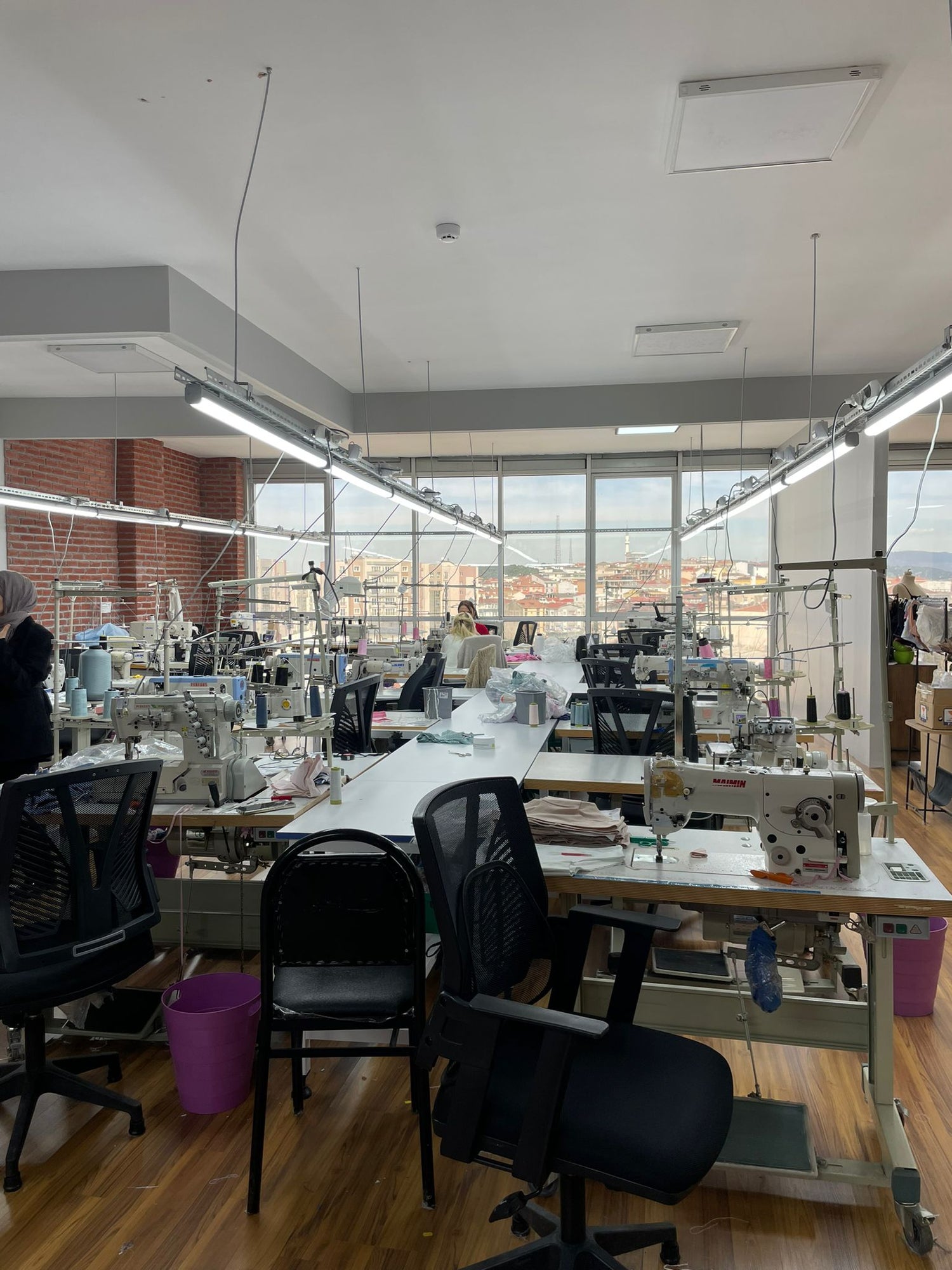 Picture of a cozy small atelier where they sew clothes.